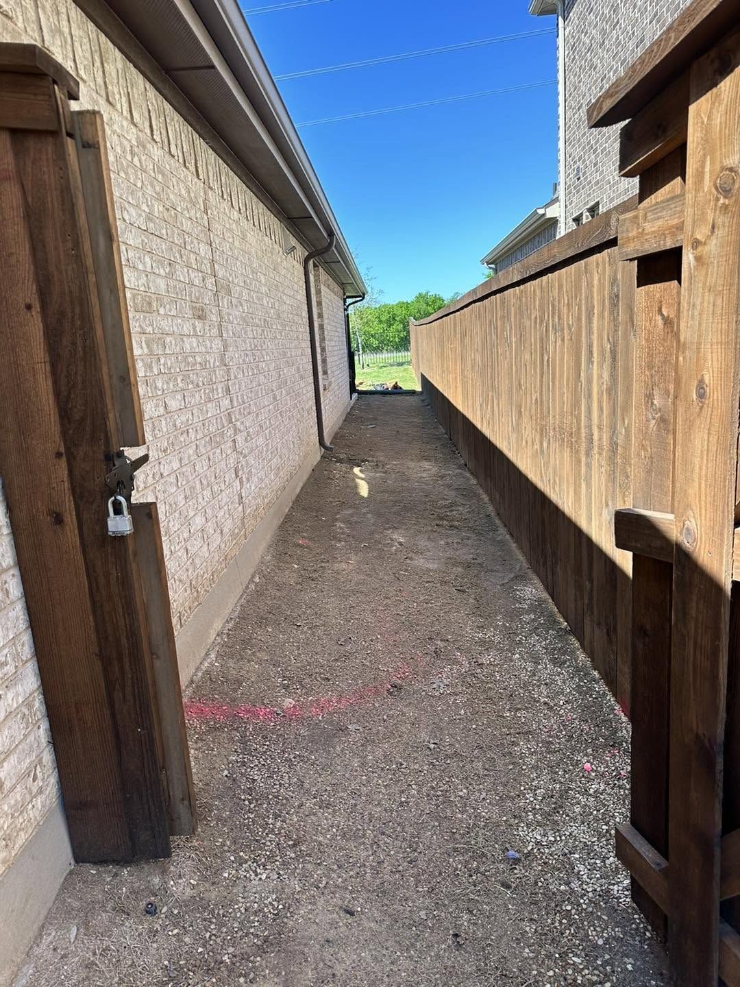 Poured concrete side yard walkway between the house and the fence
