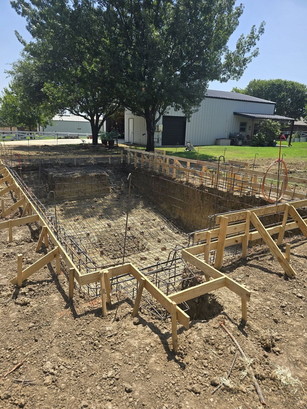 Site prep and forming before a slab pour on a DFW backyard build