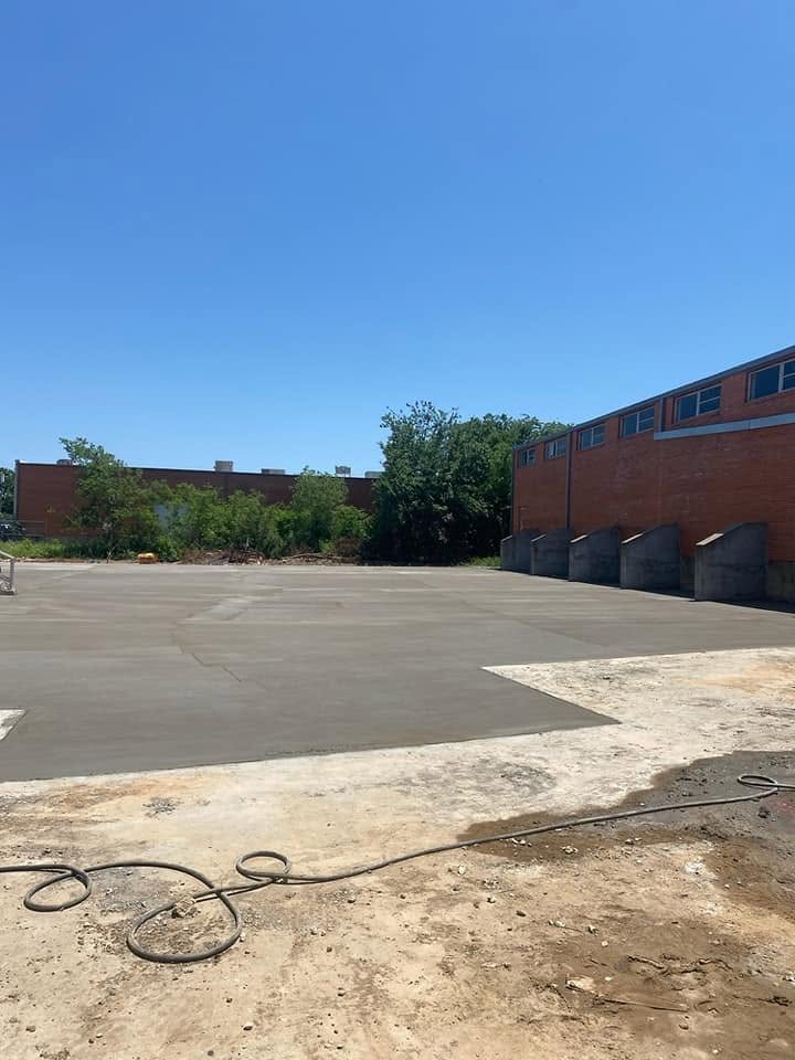 Finished commercial concrete slab poured behind a warehouse loading dock