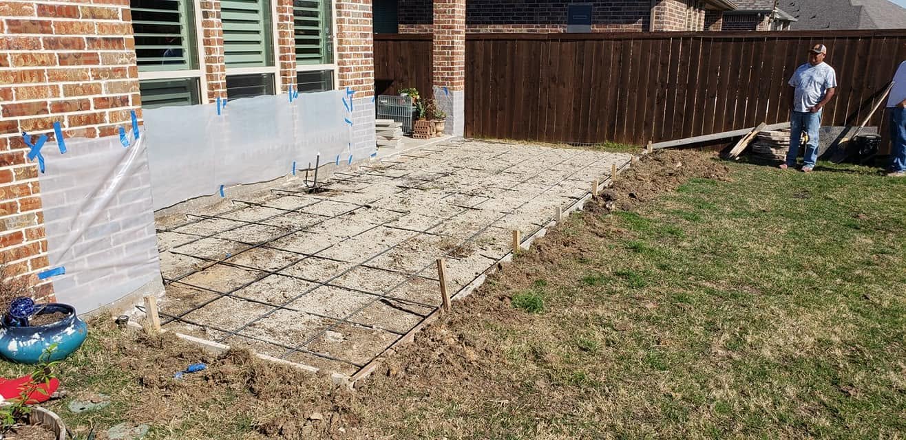 Rebar grid, vapor barrier and forms set on a compacted base before a concrete patio pour