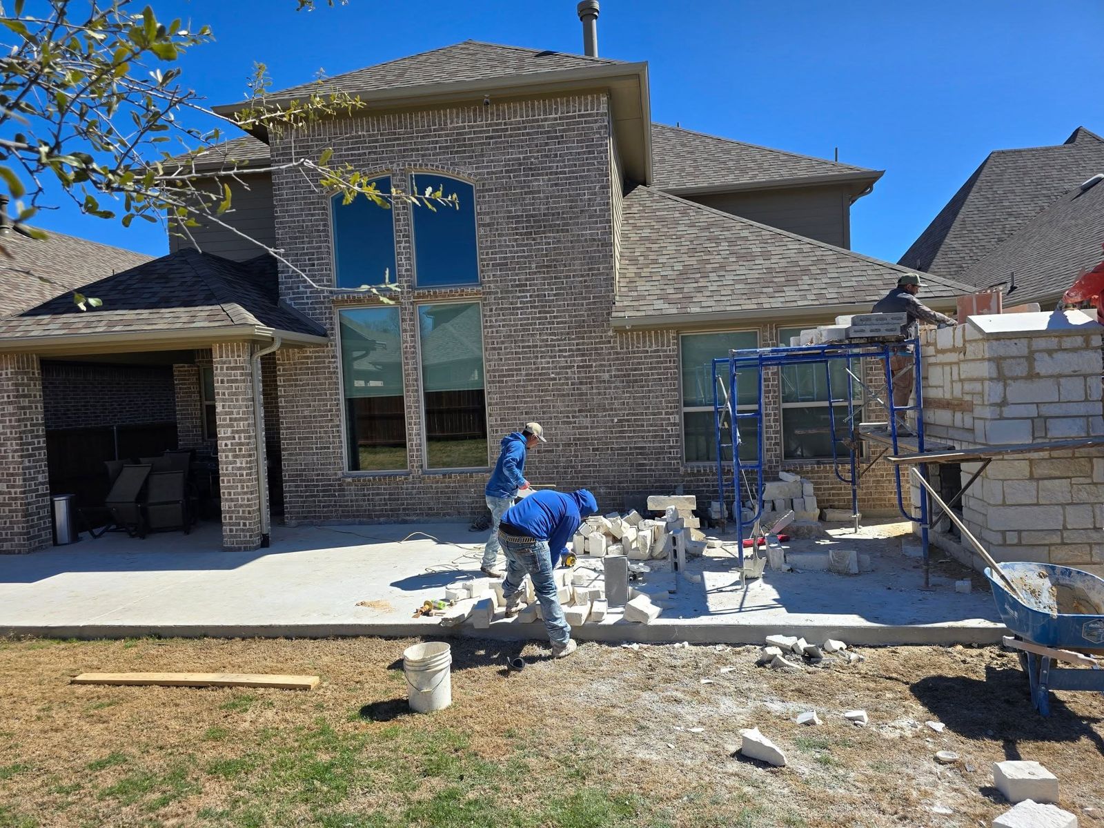 Stone and masonry work under construction on a DFW backyard build