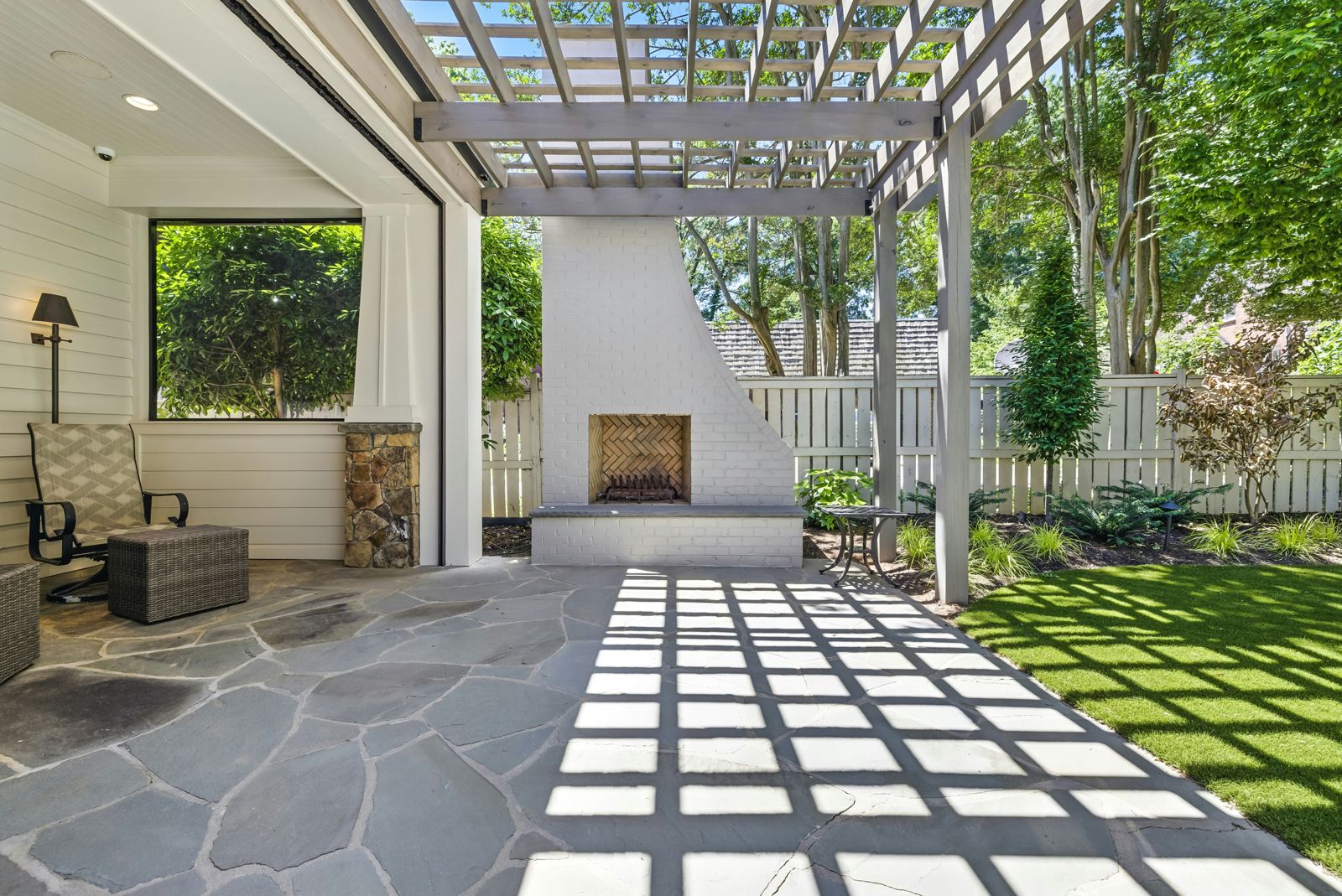 Covered patio with a flagstone floor and fireplace